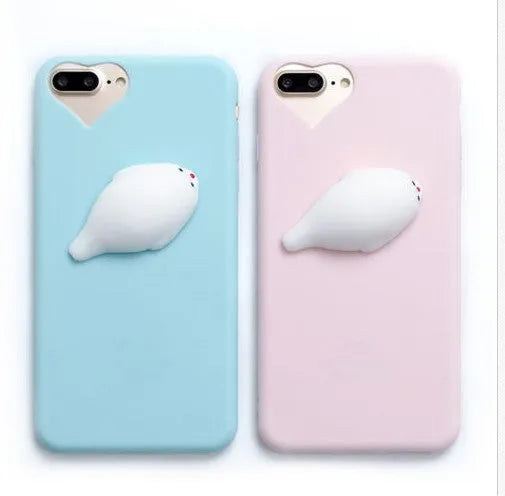 Soft silicone iPhone case with a raised 3D cartoon cat design on the back, shown in pink.