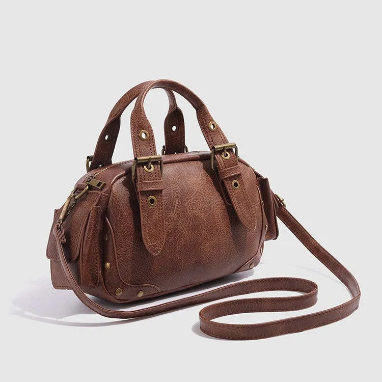Brown artificial leather motorcycle bag with single shoulder crossbody strap and horizontal square retro shape