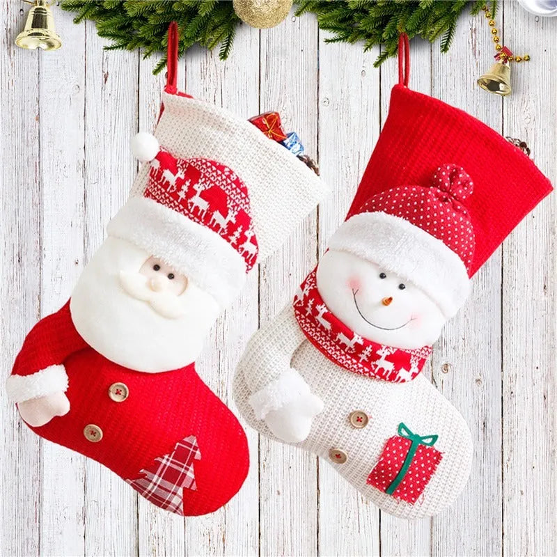 Large red and white knitted Christmas stocking with Santa Claus design hanging on a fireplace