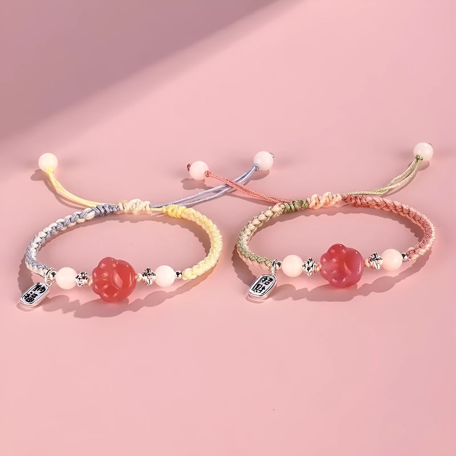 Handmade glass cat paw couple bracelet with red charm on pink or yellow woven cord
