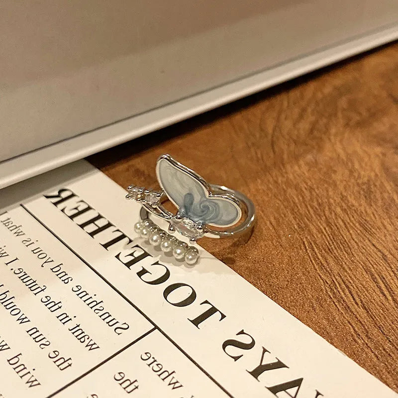 Copper butterfly women's ring with dripping oil texture and an open loop design.