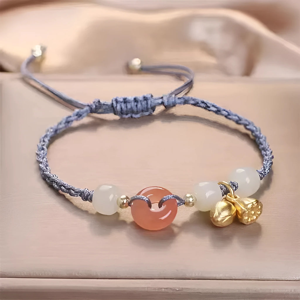 Hetian jade bracelet with constellation design and a brown carrying strap fastened with a Peace Buckle.