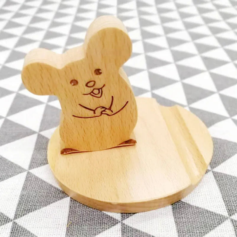 A decorative resin mobile phone stand holding a smartphone, shown in an animal design variant.
