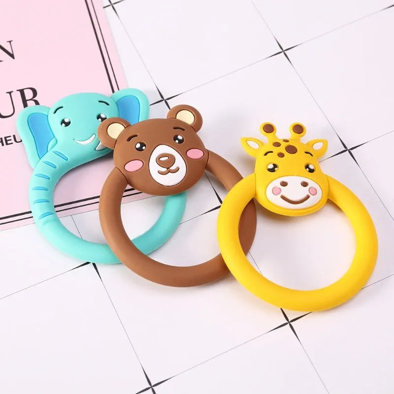 Three baby molar silicone teethers in brown, blue, and yellow on a white background
