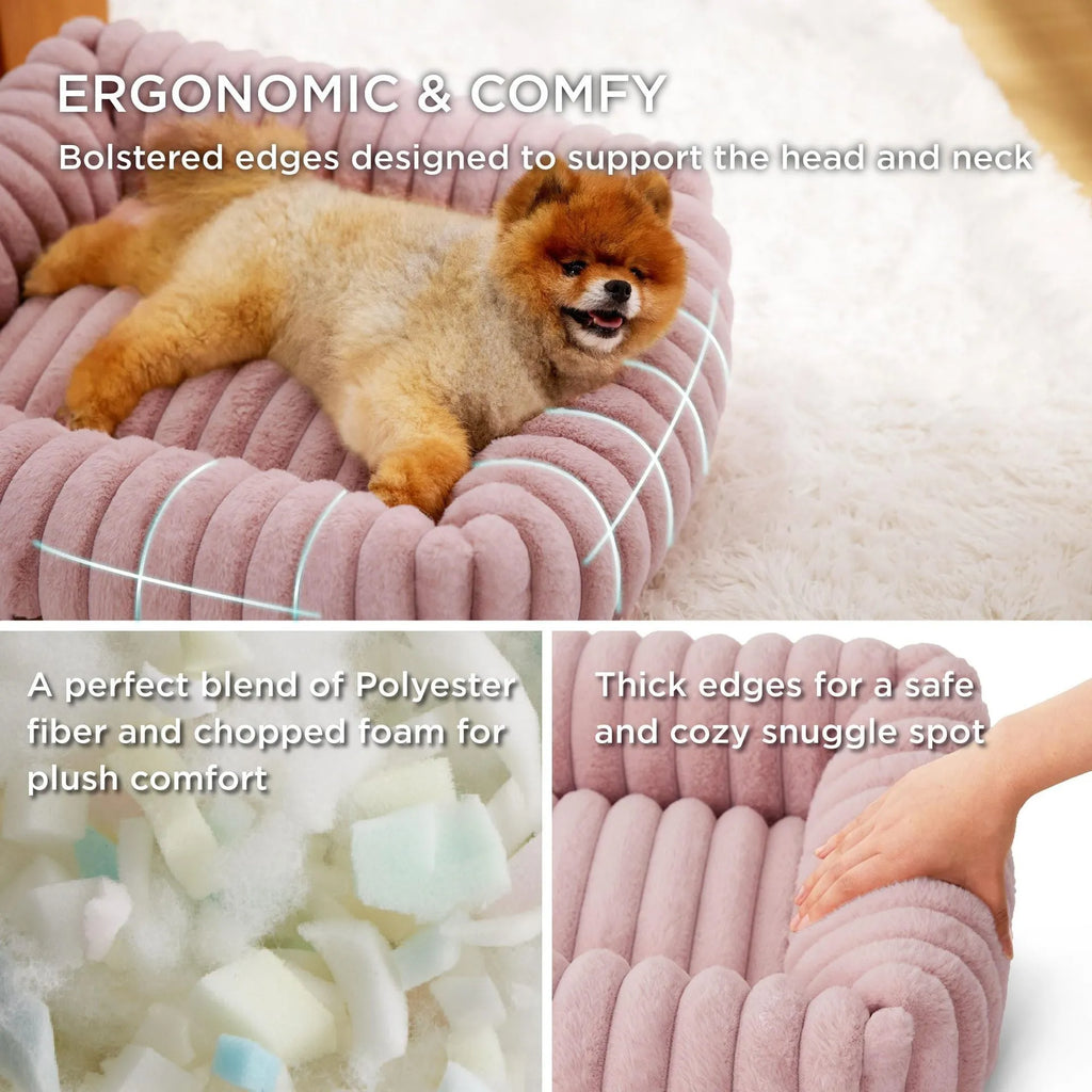 Beige plush pet bed with raised bolster sides for cats and dogs, shown in a home setting.