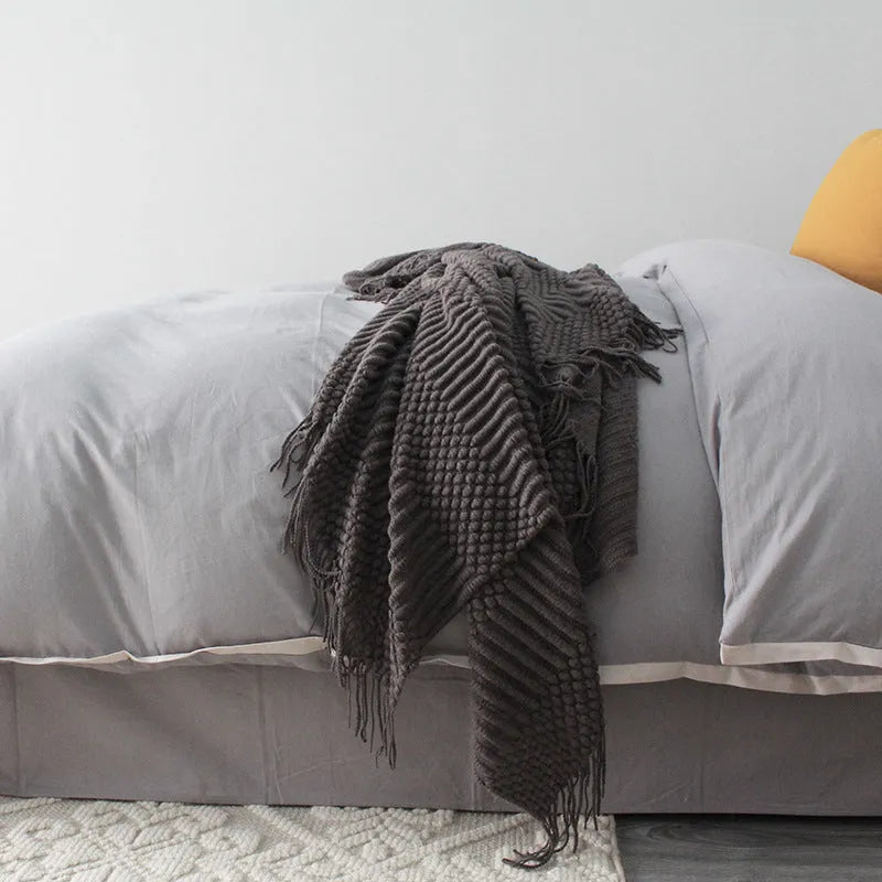 Small grey polyester lap blanket folded, showing its 127 by 170 cm size.
