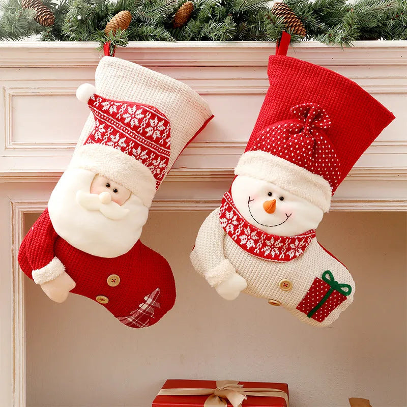 Large red and white knitted Christmas stocking with Santa Claus design hanging on a fireplace
