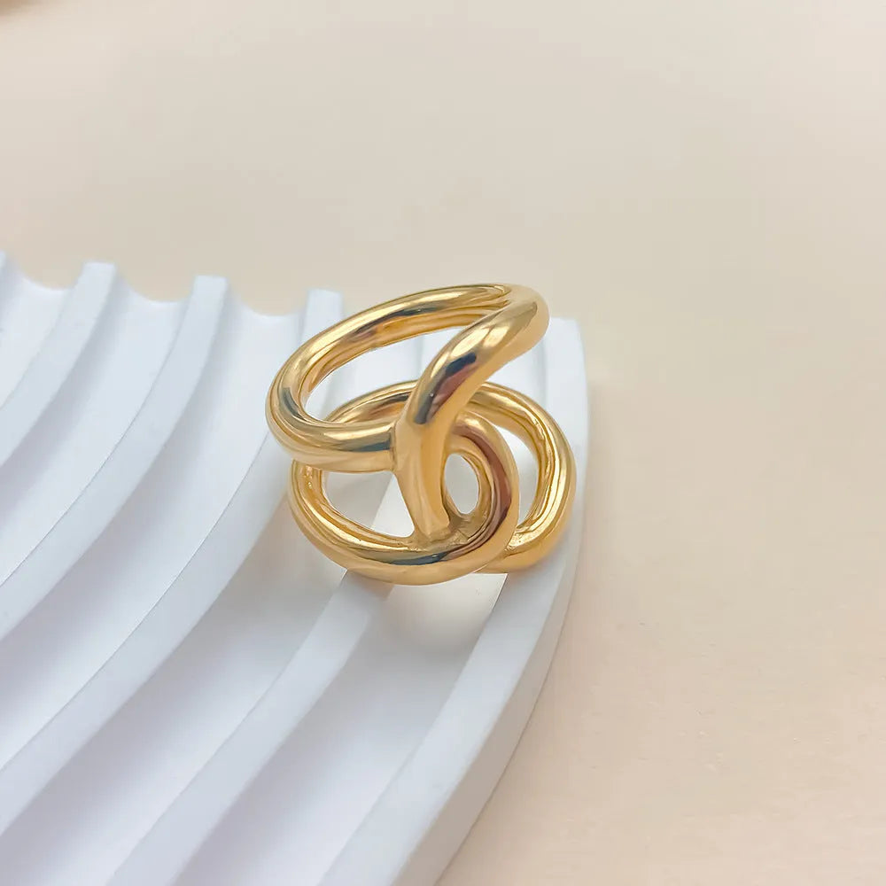 Geometric U-shaped adjustable ring for women with a knotted detail, shown in stainless steel gold tone finish.