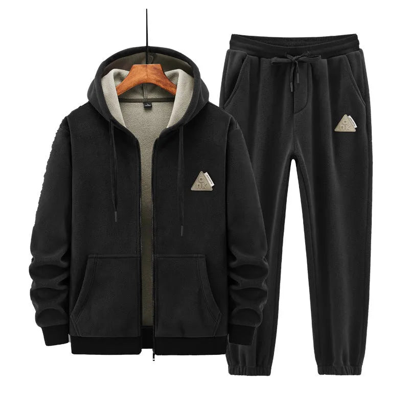 Grey hooded sweatshirt and matching trousers sports suit set laid flat
