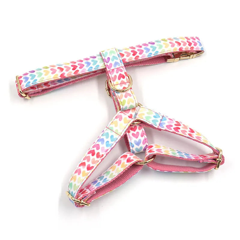 Pink dog harness with gold buckle and colourful heart-shaped stone decoration in four sizes