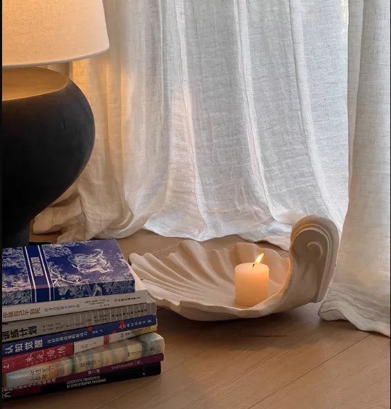 White resin fruit plate ornament with simulated shell storage design on wooden table