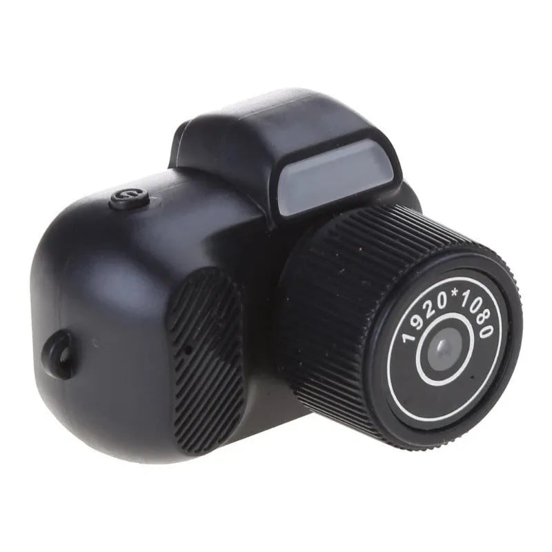 Black retro-style mini digital video camera with small screen shown on a table.