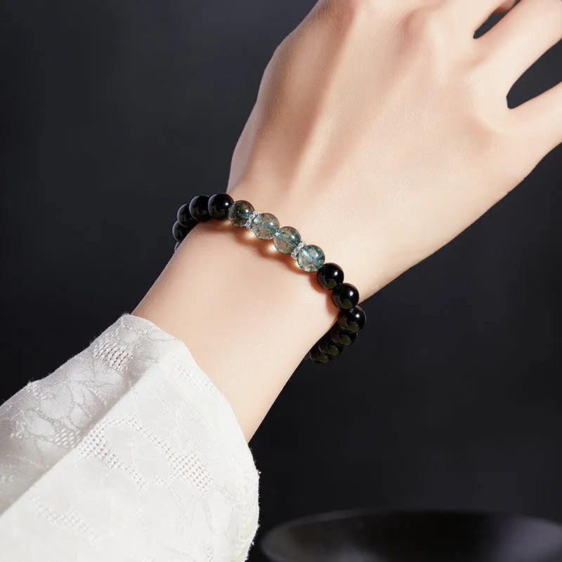 Chinese style black geometric bead bracelet with sterling silver components on wrist