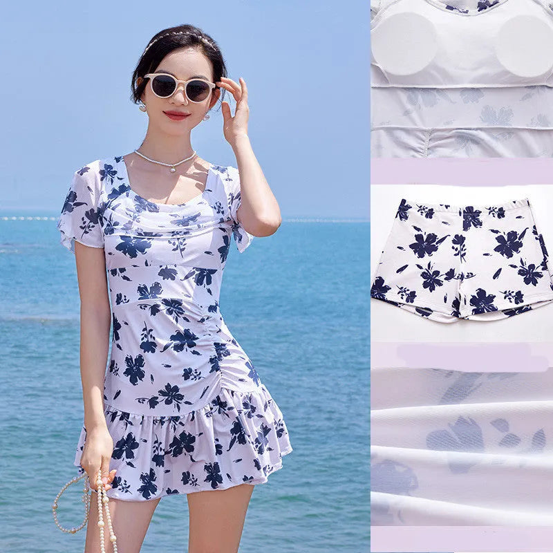Women's white mesh short sleeve one-piece swimming dress on a mannequin.