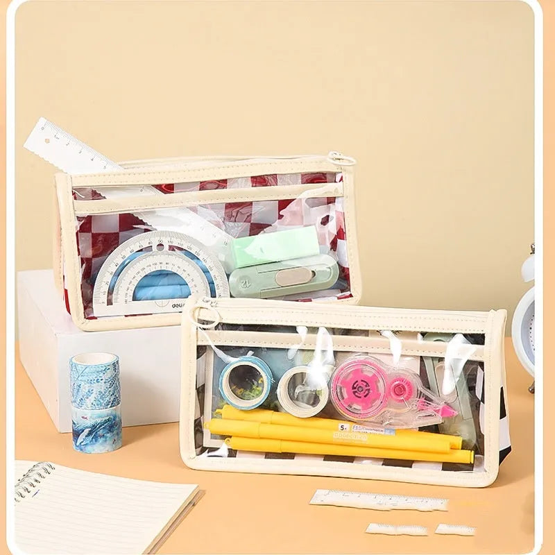 Transparent PVC pencil case with a chessboard grid pattern, showing pens inside, next to a red and white plaid version.