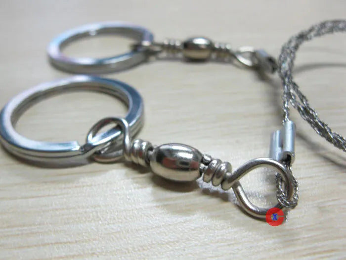 Stainless steel survival wire saw with pull rings showing 55cm cutting blade and extended 70cm total length