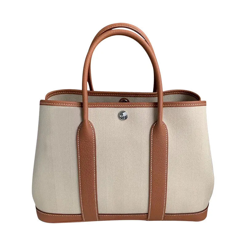 Women's genuine leather canvas tote bag in bucket shape with internal organisation pockets