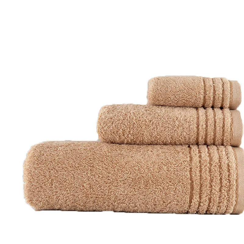 Set of three cotton towels in beige and brown colours, showing small, medium, and large sizes.