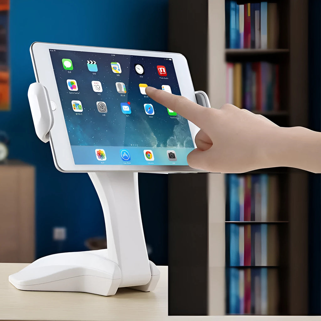 White adjustable tablet stand with metal frame and silicone clip, holding a tablet on a desk.