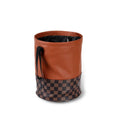 Brown leather retractable car trash can shown in a folded state with a carry handle.