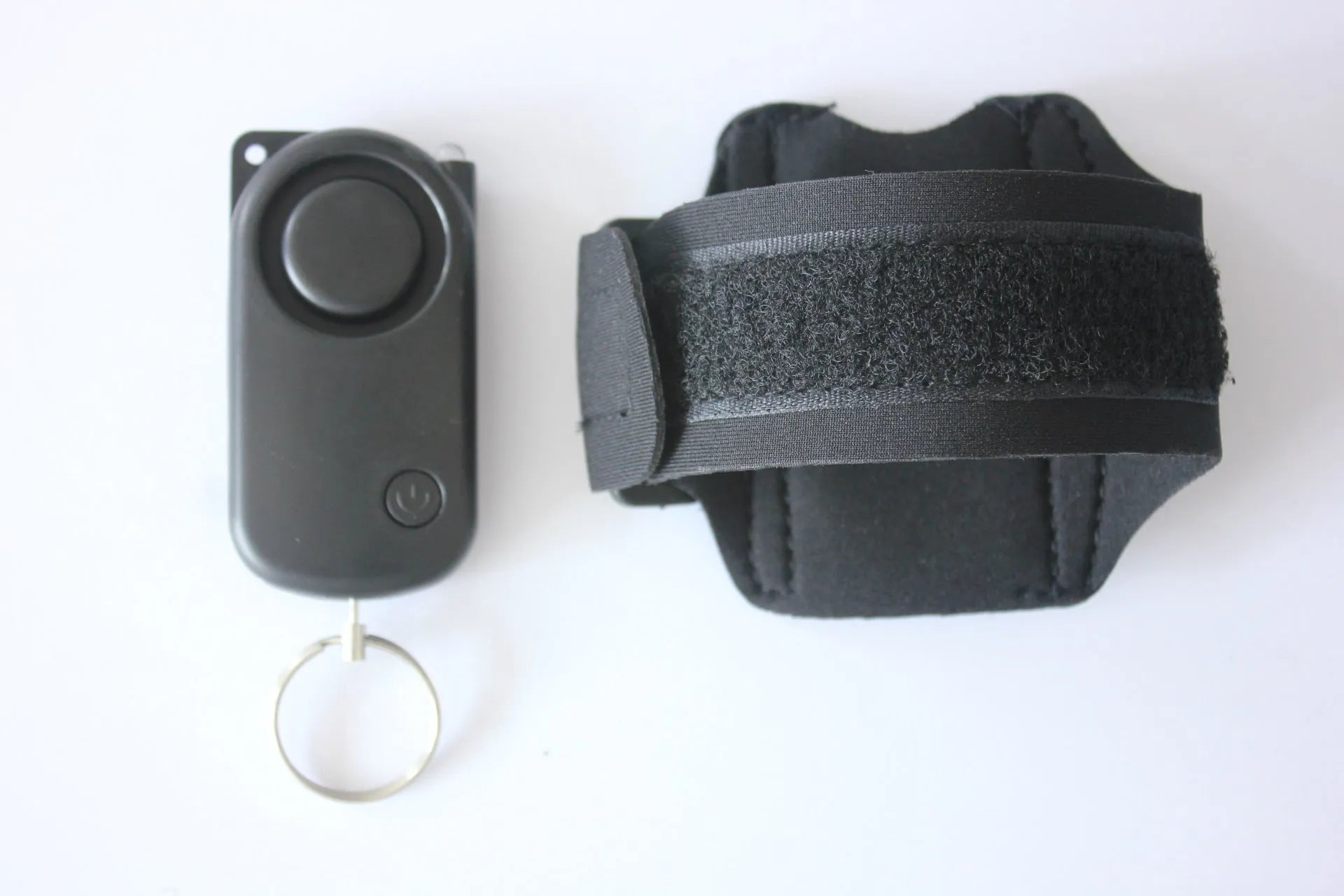 Runner Personal Alarm with LED flashing light and adjustable black wristband on white background