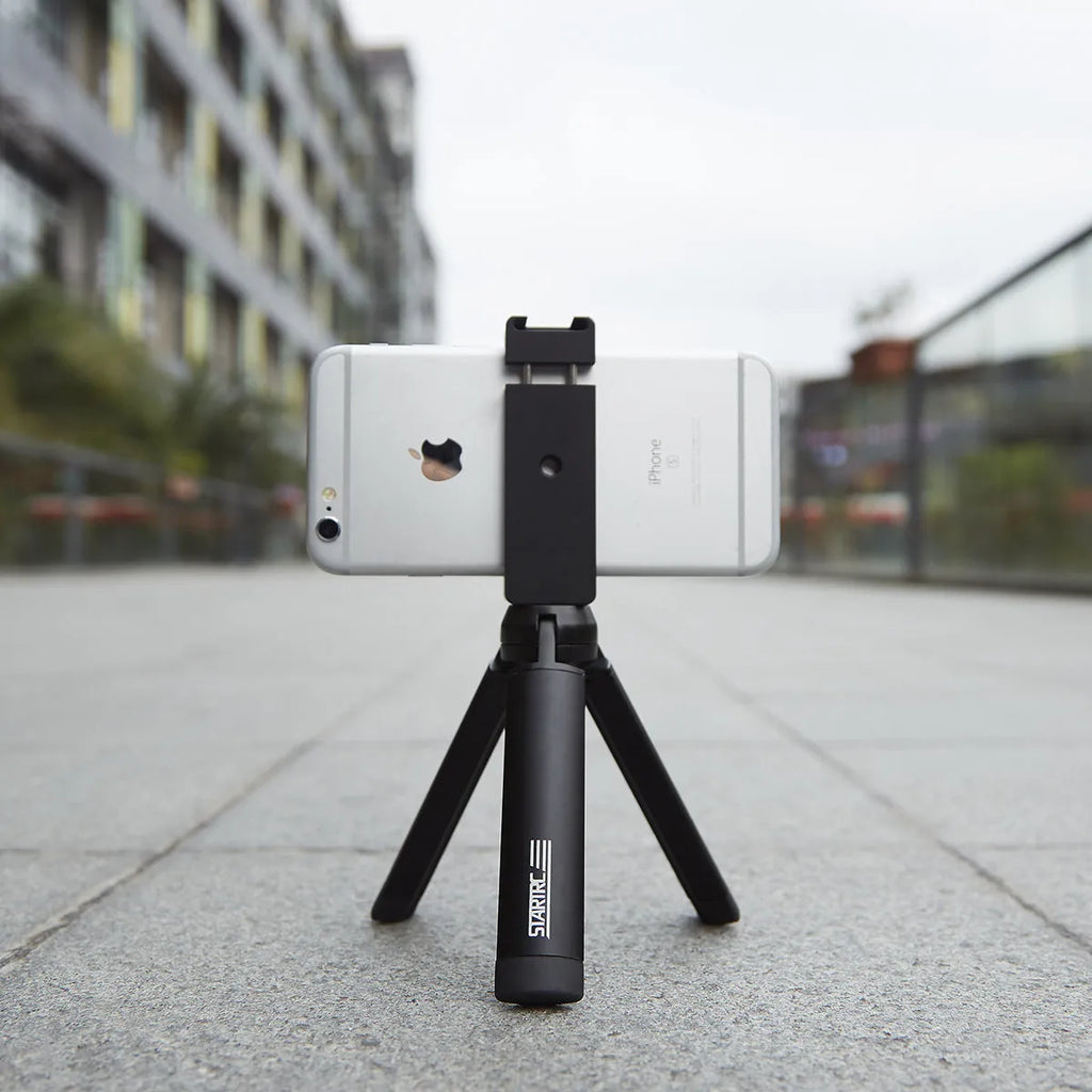 Aluminium alloy handheld bracket accessory for mounting an iPhone onto a table top tripod.