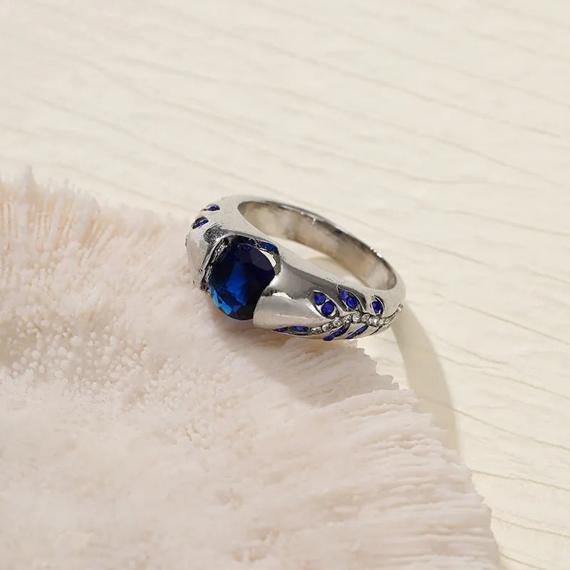 Leaf style zinc alloy ring with round zirconium inlay in gold colour on white background