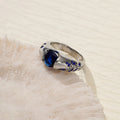 Leaf style zinc alloy ring with round zirconium inlay in gold colour on white background