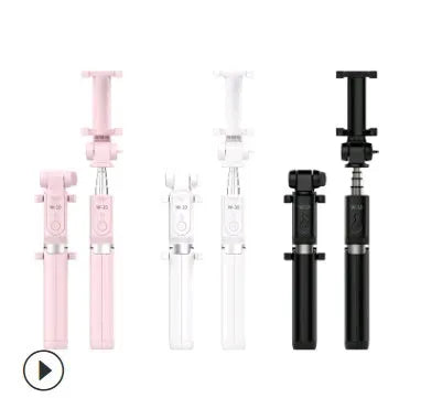 Black Bluetooth selfie stick with tripod base and remote control extended next to smartphone