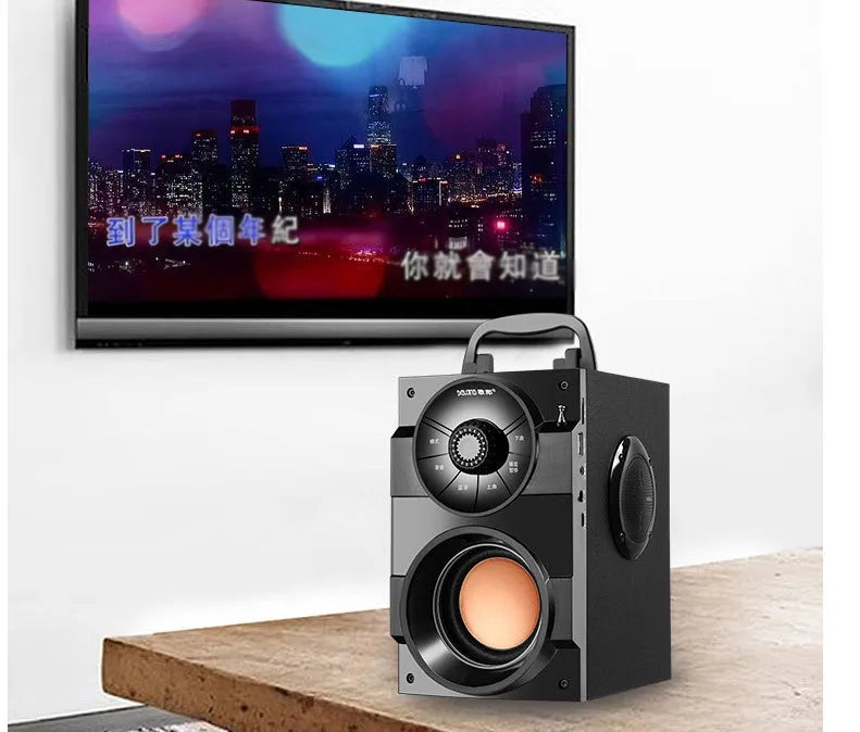 Compact black portable audio system with subwoofer, connection cable, and USB power input.