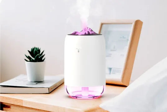 Mini cylindrical USB humidifier with night light in turquoise green, showing water tank and mist outlet