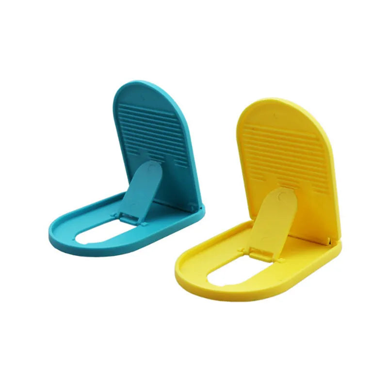 Plastic lazy bracket mobile phone stand in one of six colour options on a desk