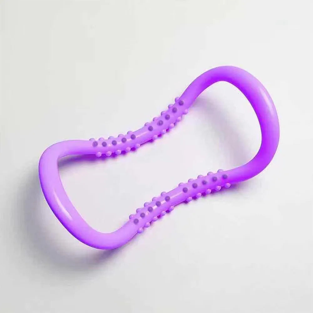 A purple PP plastic yoga ring or Pilates stretching roller on a plain background.