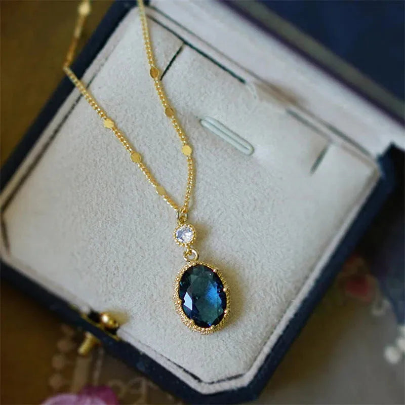 Gold geometric pendant necklace with a French retro design on a model.