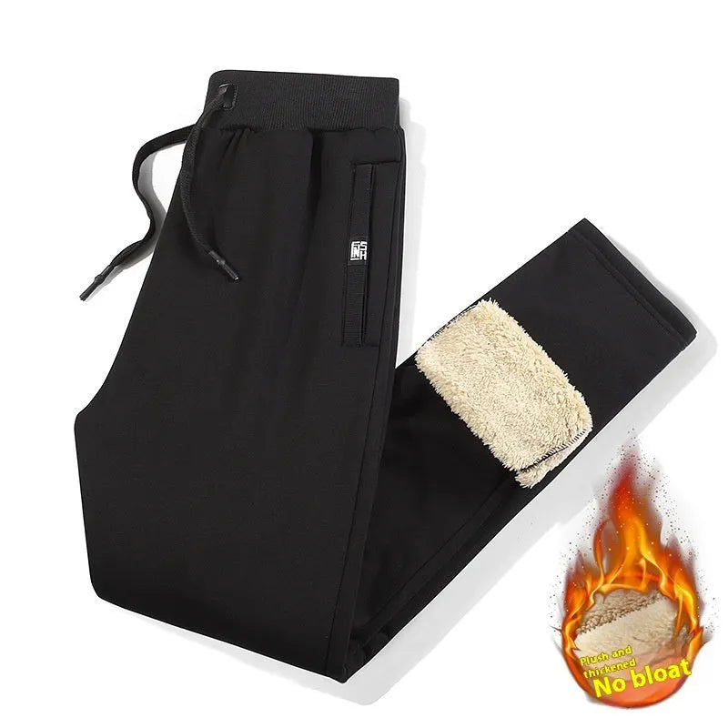 Men's grey fleece-lined cotton oversized track pants with a straight leg, laid flat.