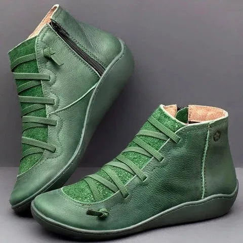 Women's casual flat ankle boots in artificial PU leather with a round toe and wedge rubber sole.