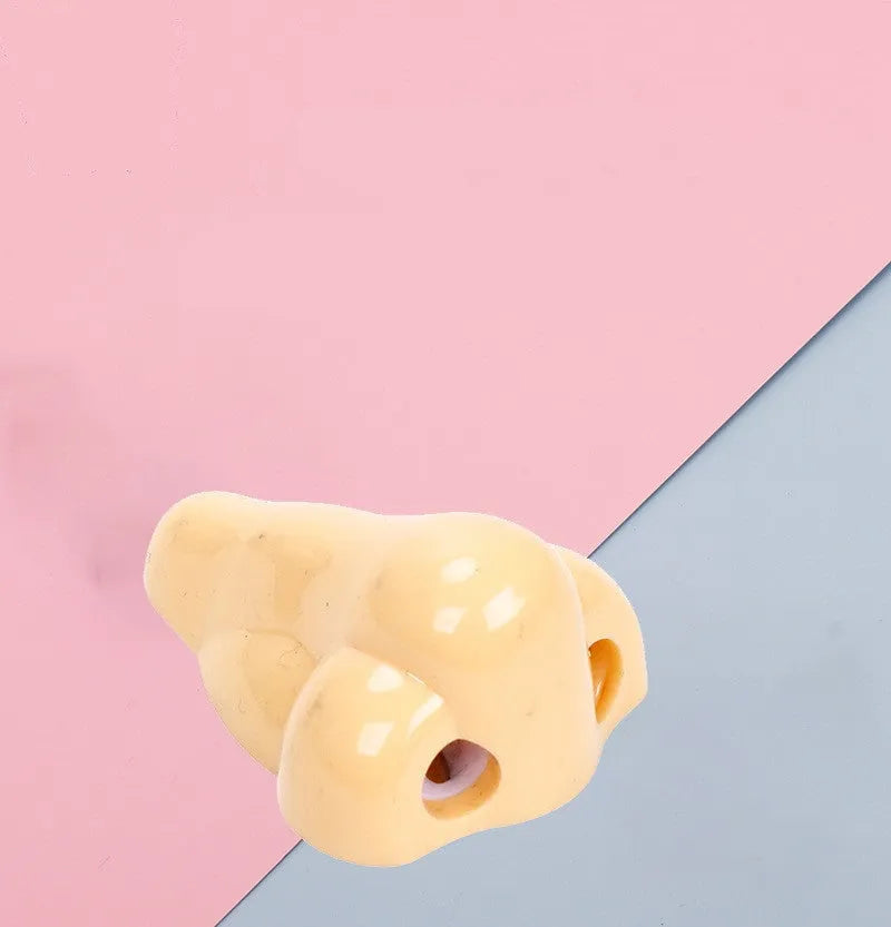 Flesh colour plastic manual pencil sharpener with big nostril, showing geometry shape.