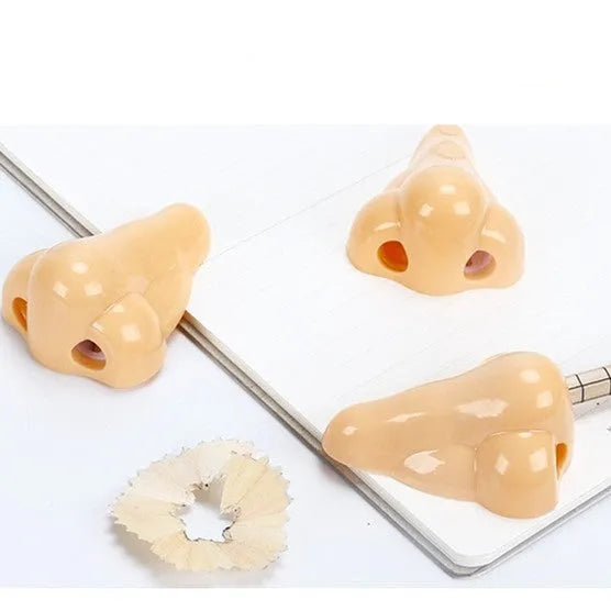 Flesh colour plastic manual pencil sharpener with big nostril, showing geometry shape.