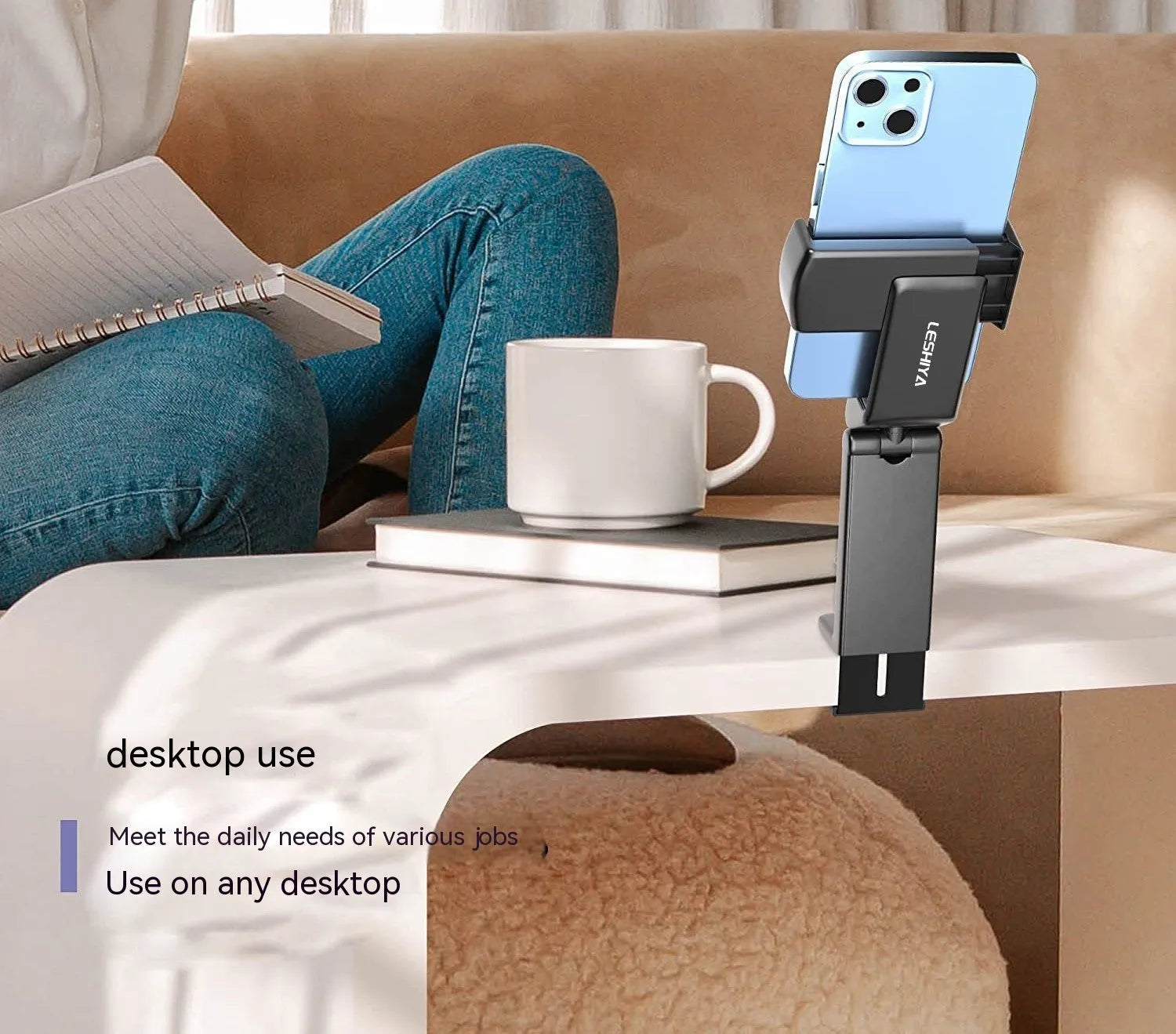 Black foldable and rotating universal mobile phone holder on a table.