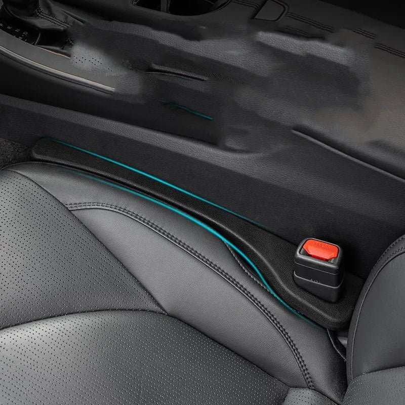 Two polyresin car seat gap sealing strips in chosen colour, shown next to a vehicle seat.