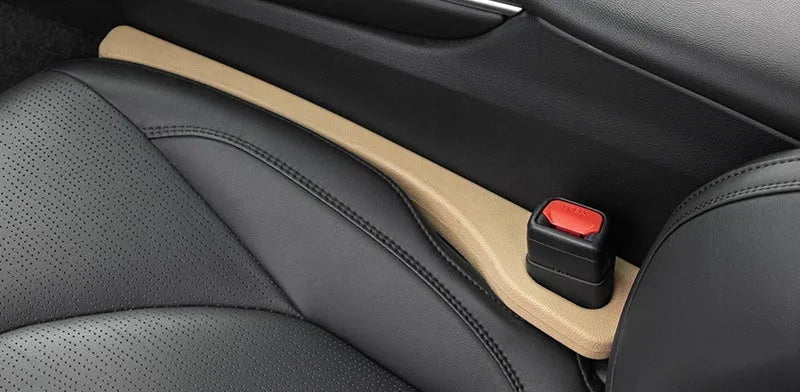 Two polyresin car seat gap sealing strips in chosen colour, shown next to a vehicle seat.