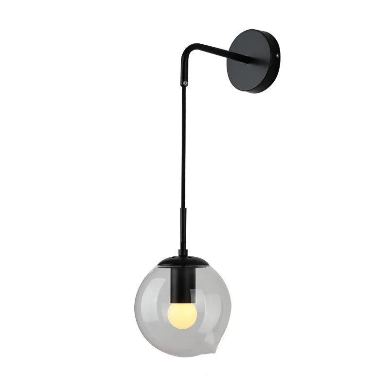 Nordic glass wall lamp with amber glass shade, black metal body, mounted on wall