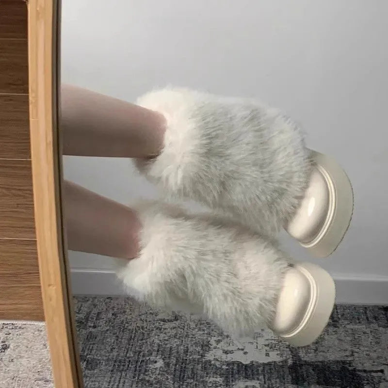 Women's black artificial plush snow boots with a waterproof rubber sole and round toe design.