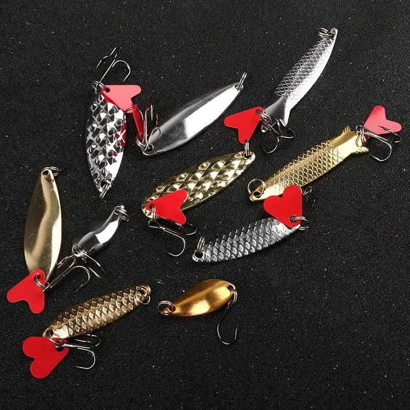 Metal pineapple-shaped fishing lure with sequin attachments in gold and silver colours