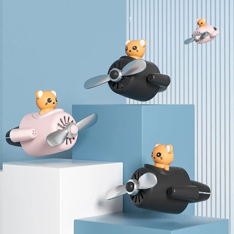 Cartoon aeroplane-shaped plastic clip for car air vent with three fragrant slices.