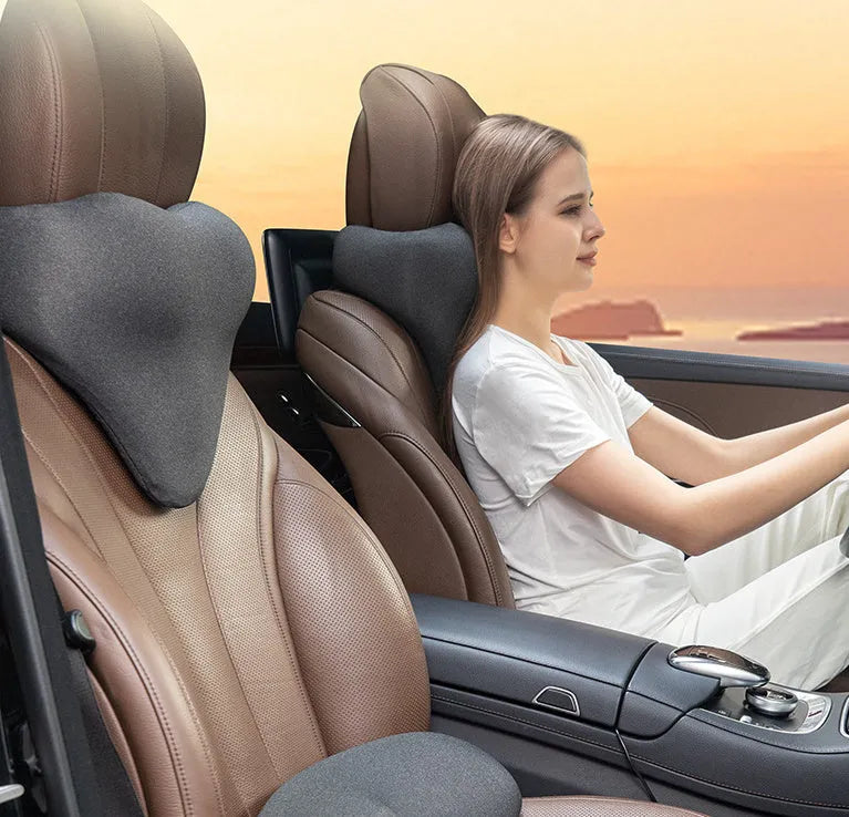 Solid-colour memory foam car neck pillow on a car headrest in dark grey, grey, or fog blue
