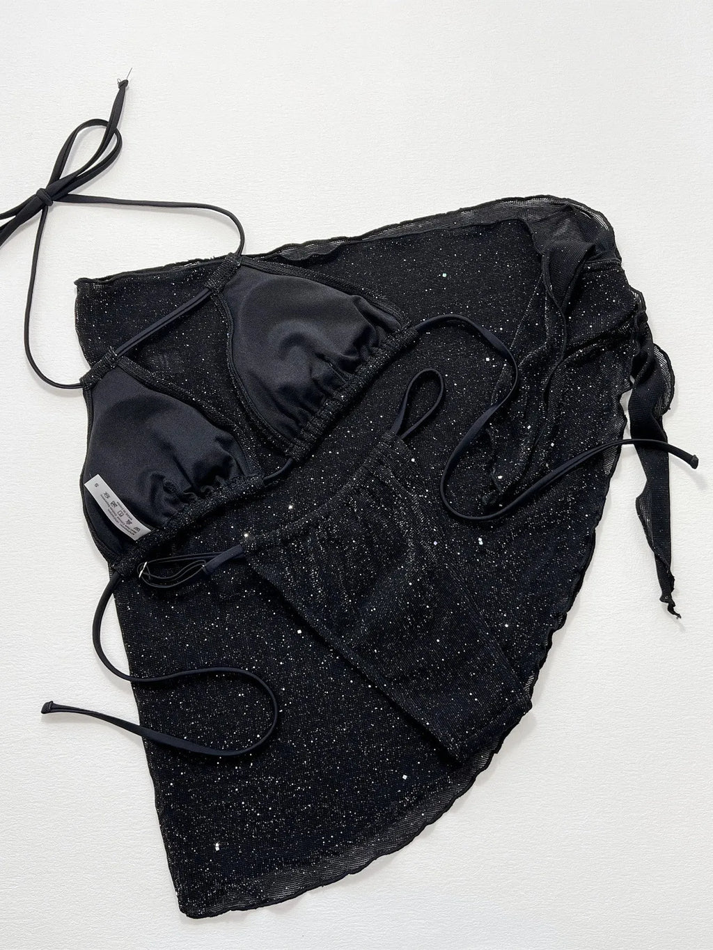 Black three-piece bikini swimsuit set with top and shorts on mannequin