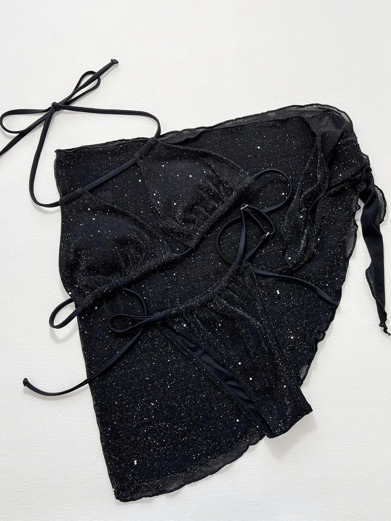 Black three-piece bikini swimsuit set with top and shorts on mannequin