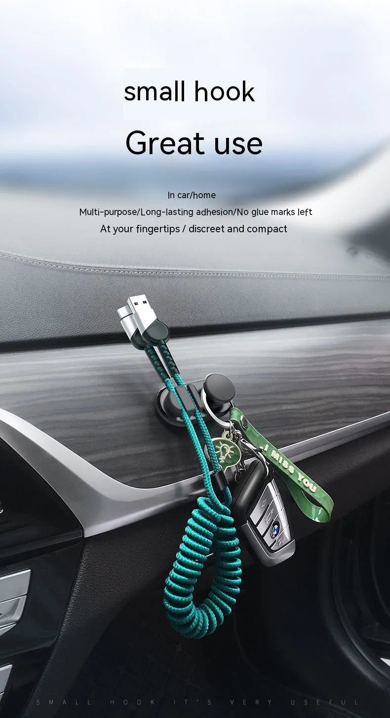 Adhesive car storage hook for cables in dark green colour showing dimensions and mounting surface