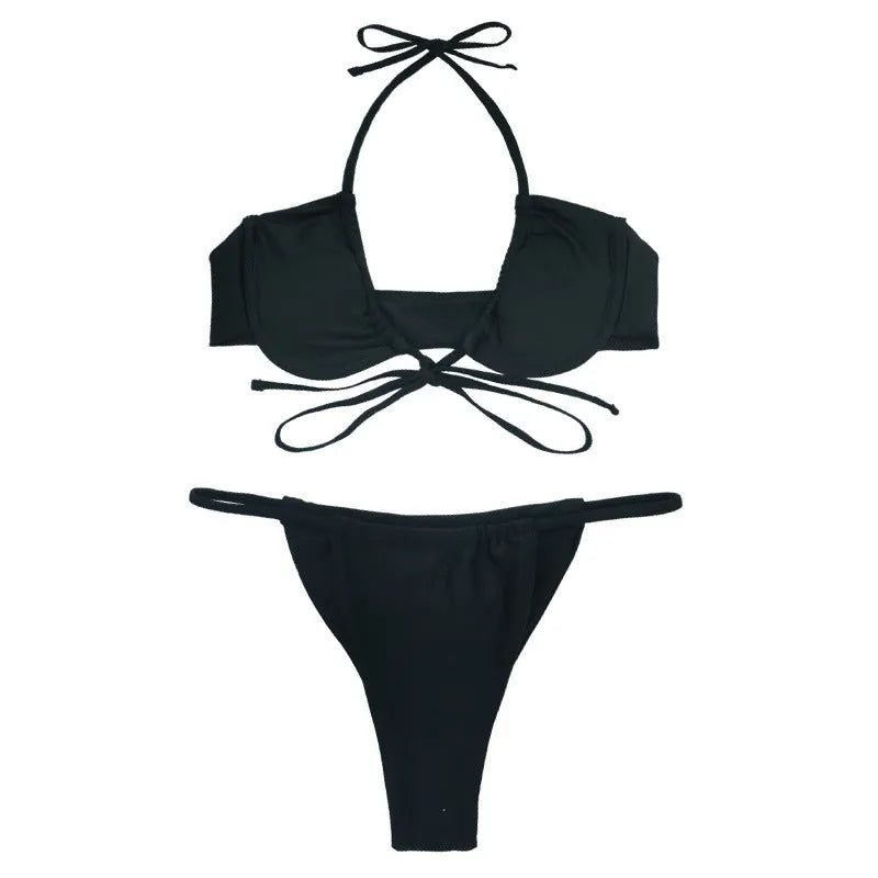 Women's black and mint green two-piece nylon bikini swimsuit on a mannequin.